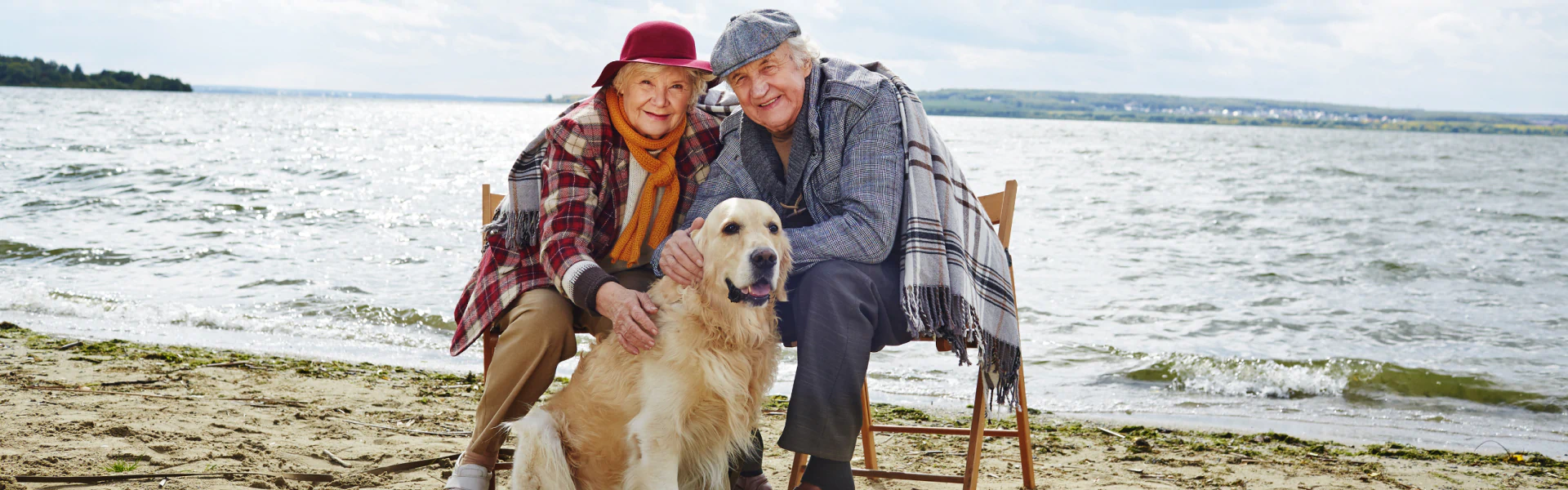retired couple with dog at beach